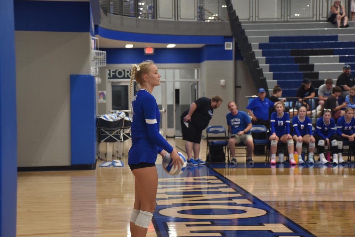 Junior Libby Jensen prepares for serve to the opposing team.