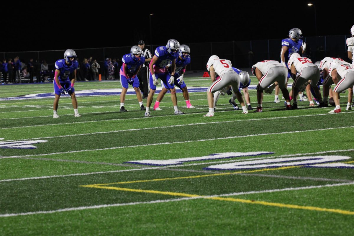 Owatonna's football team lines up against West waiting for the play to start. 