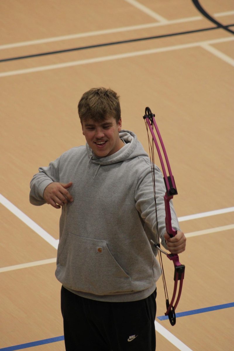 Jack Meneguzzo smiling after shooting his arrow.