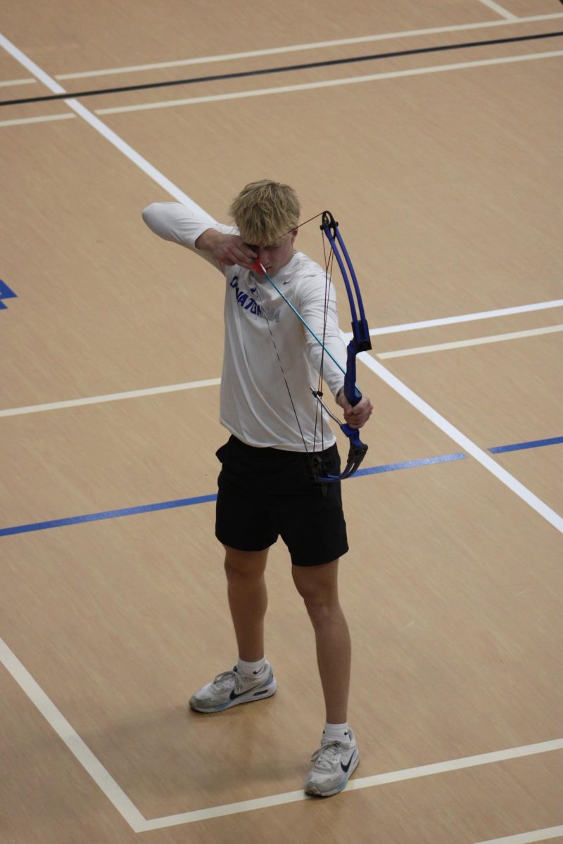 Andy Mitchell Shooting a bow and arrow in Lifetime activities.