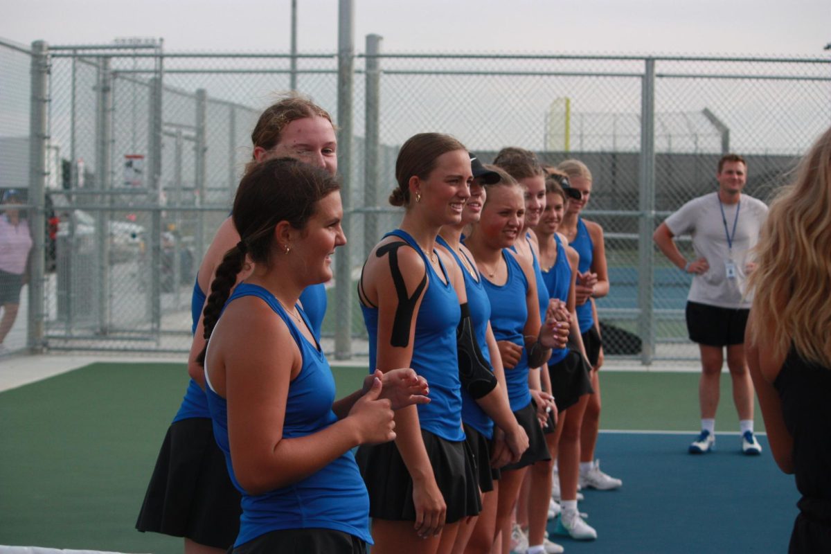 Owatonna Girls Tennis team preparing for introductions. 