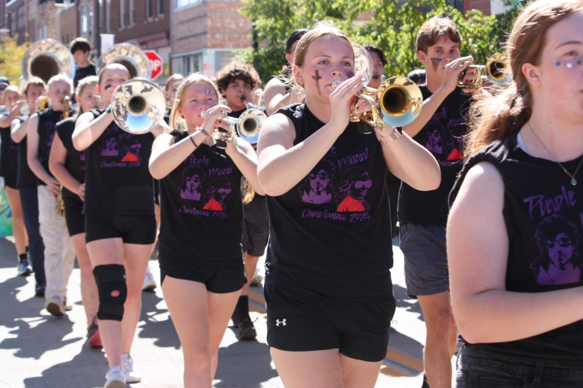 Senior Makenzie Oltmans playing the trumpet in the homecoming parade.