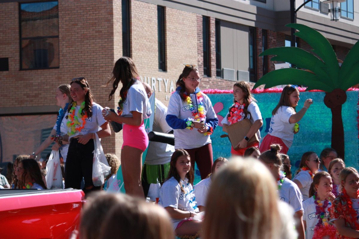 OHS Girls Swim team looked ahead at the audience and threw candy.