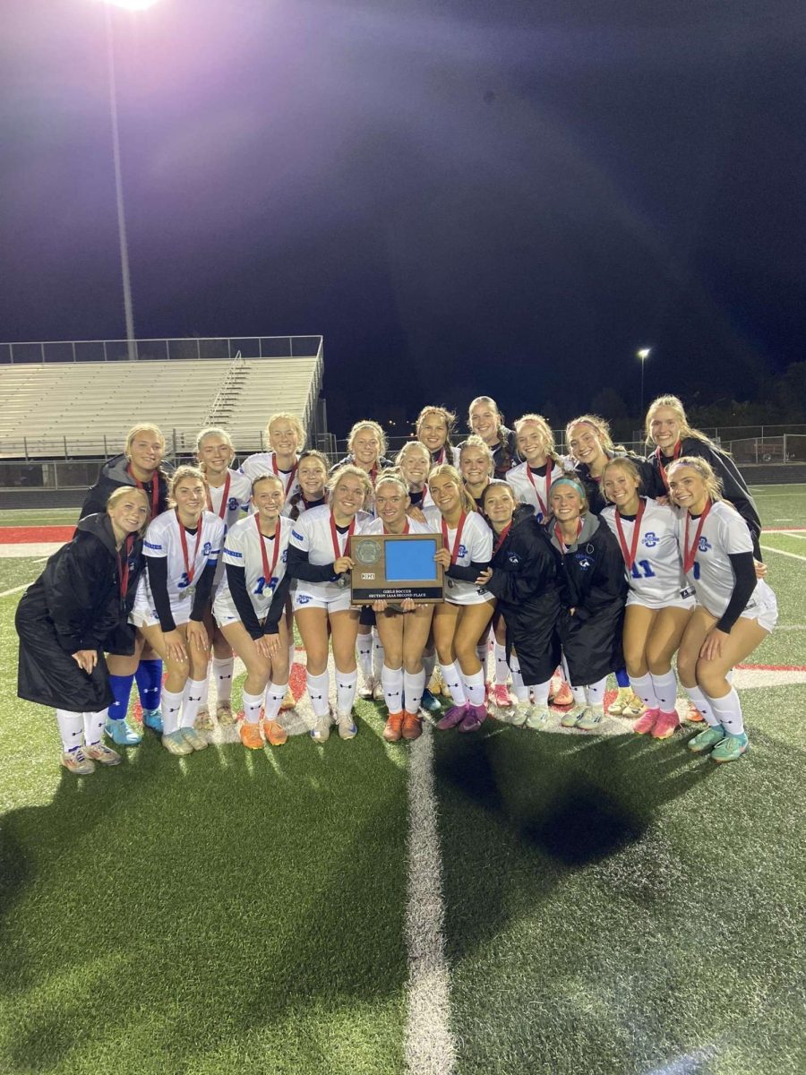 Owatonna Girls Varsity team with their second place section plaque after the section championship. 