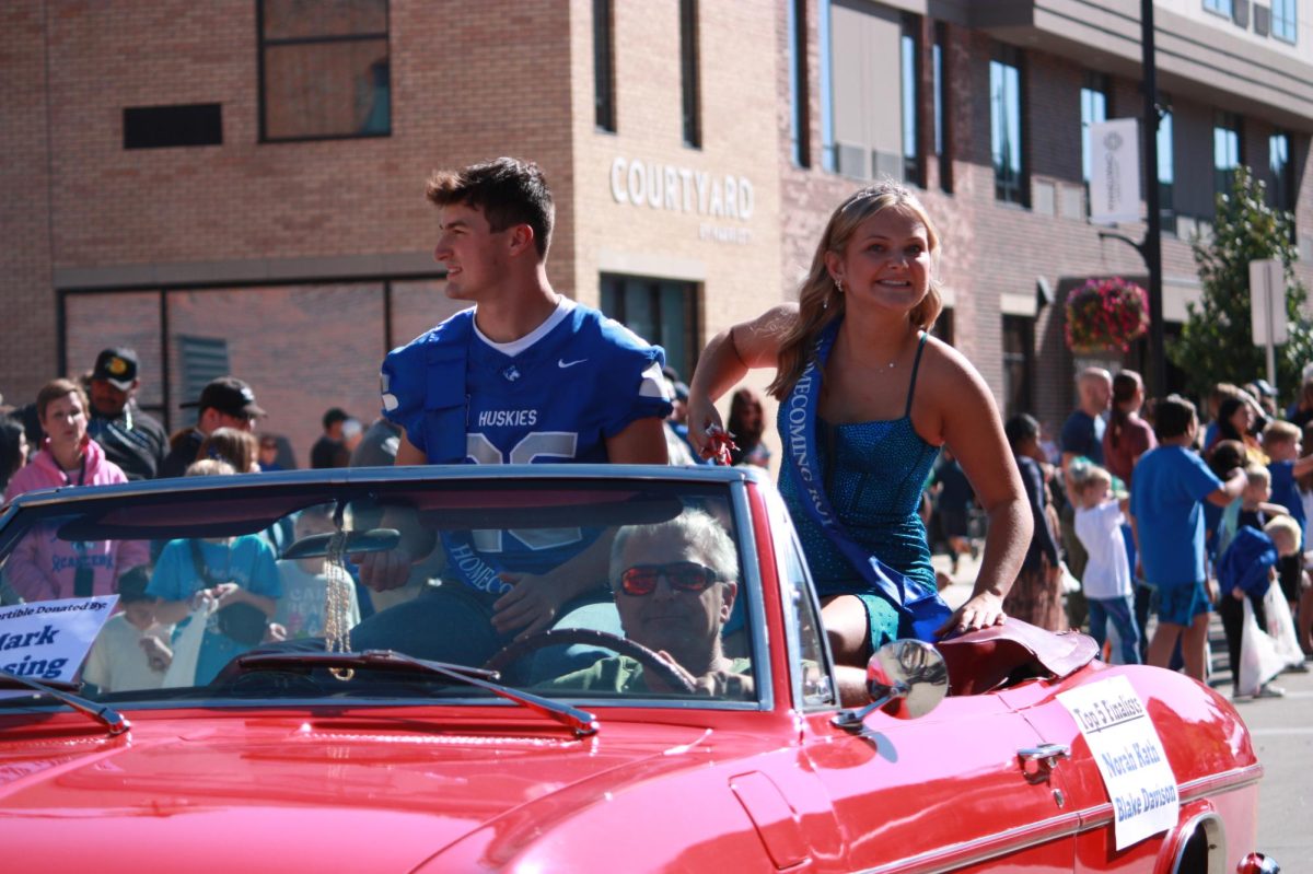 Senior Blake Davison and Senior Norah smile and throw out candy during the parade.