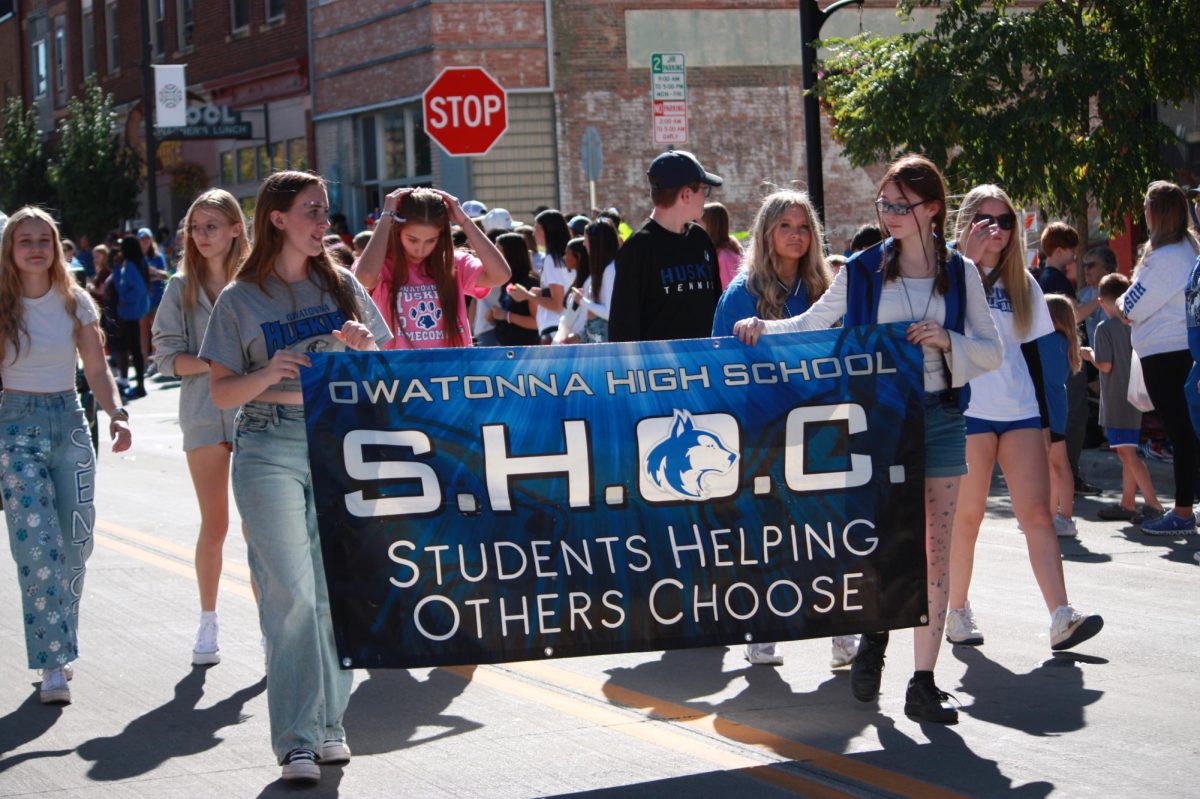 Owatonna High School S.H.O.C members carried S.H.O.C tapestry at the parade. 