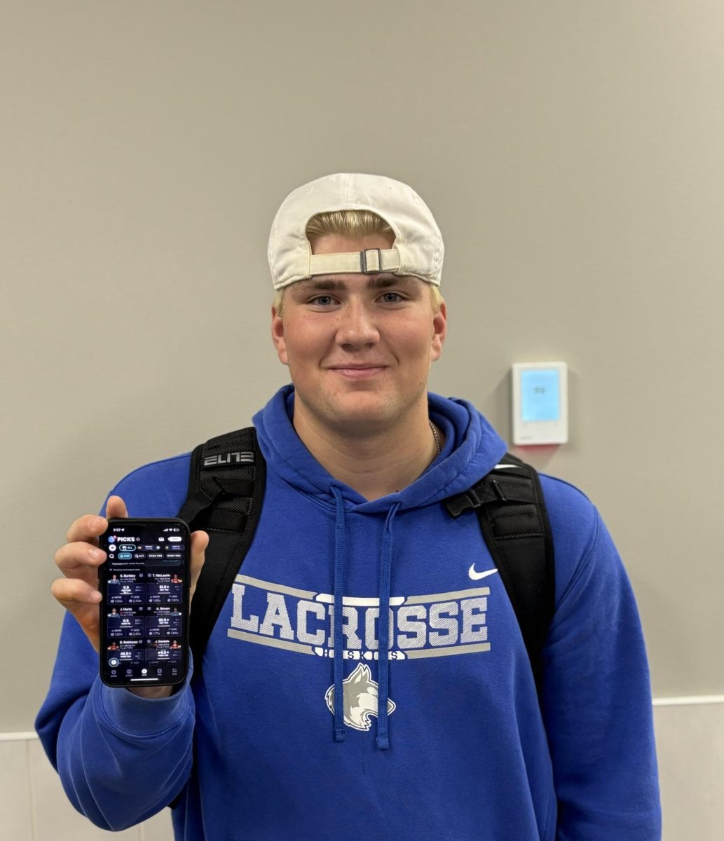 Senior Michael Heitkamp gambles on sports gambling app.