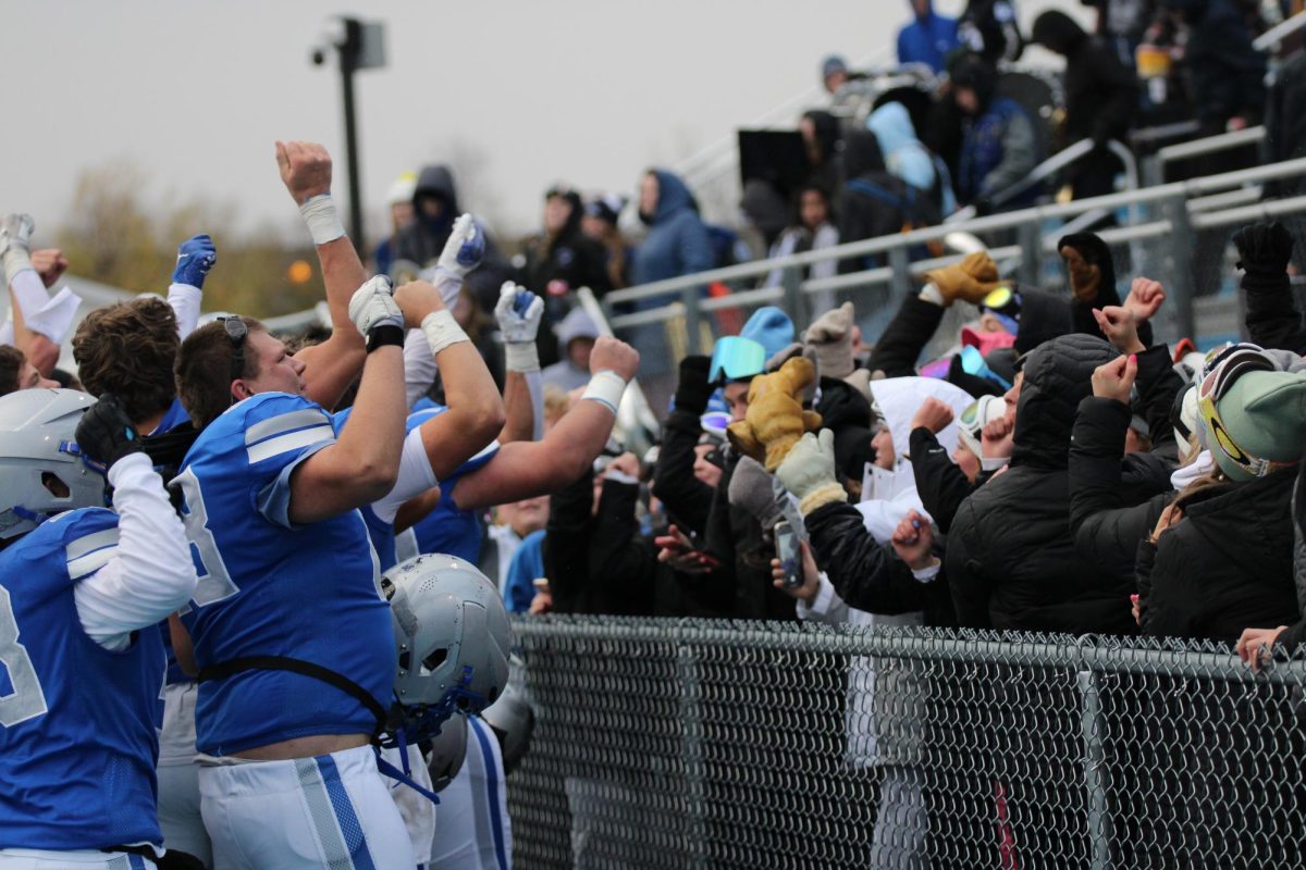 OHS Football team rush to the fence to celebrate their victory with OHS student section. 