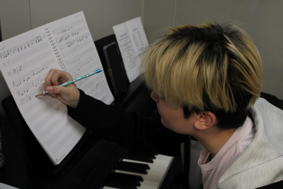 Senior Leo Malchow composes an original piece in the music wing.