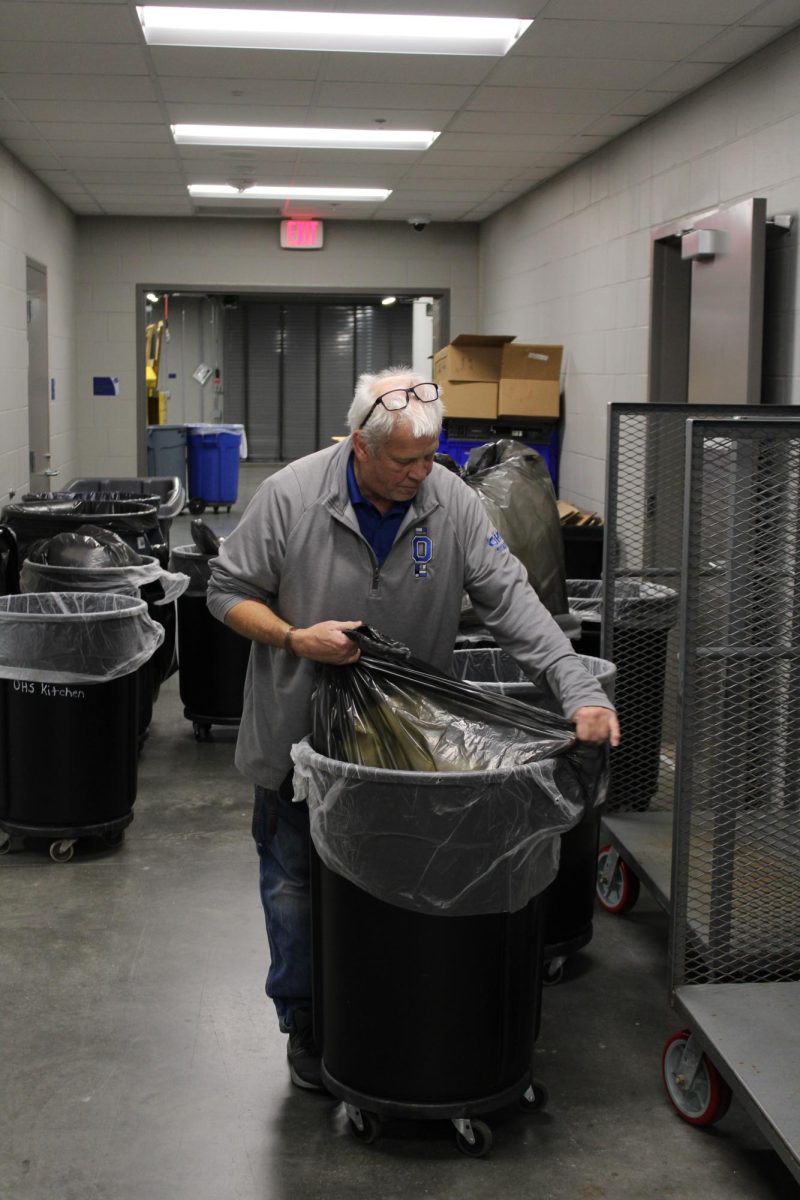 Custodian Dana Germundson cleans up after lunch, keeping the school running.