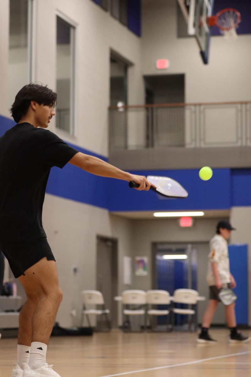 Senior Zach Knott plays pickleball at the NHS tournament. NHS participated in Give Week by hosting a pickleball tournament.