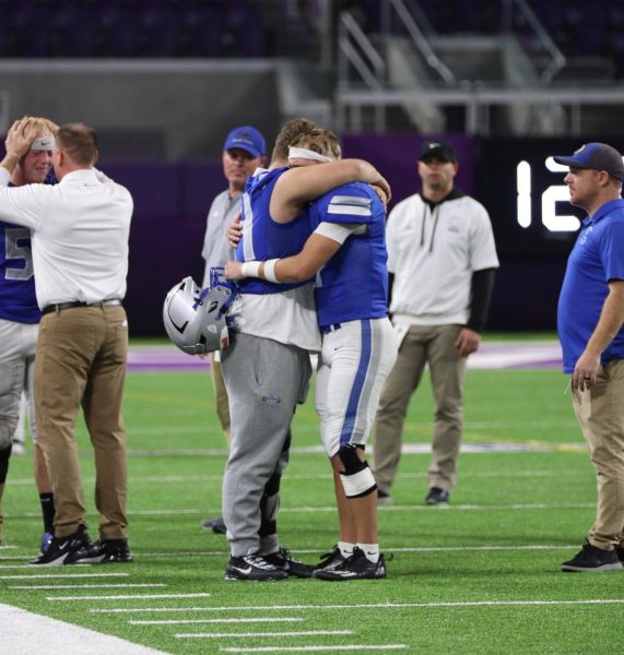 Senior Jack Meneguzzo and senior Luke Webber sadly embrace after their team's tough loss against the Alexandria Cardinals at US Bank Stadium. 