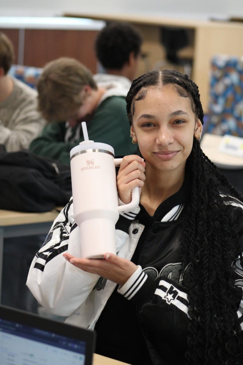 Senior Danity Erickson is holding up her Stanley cup.