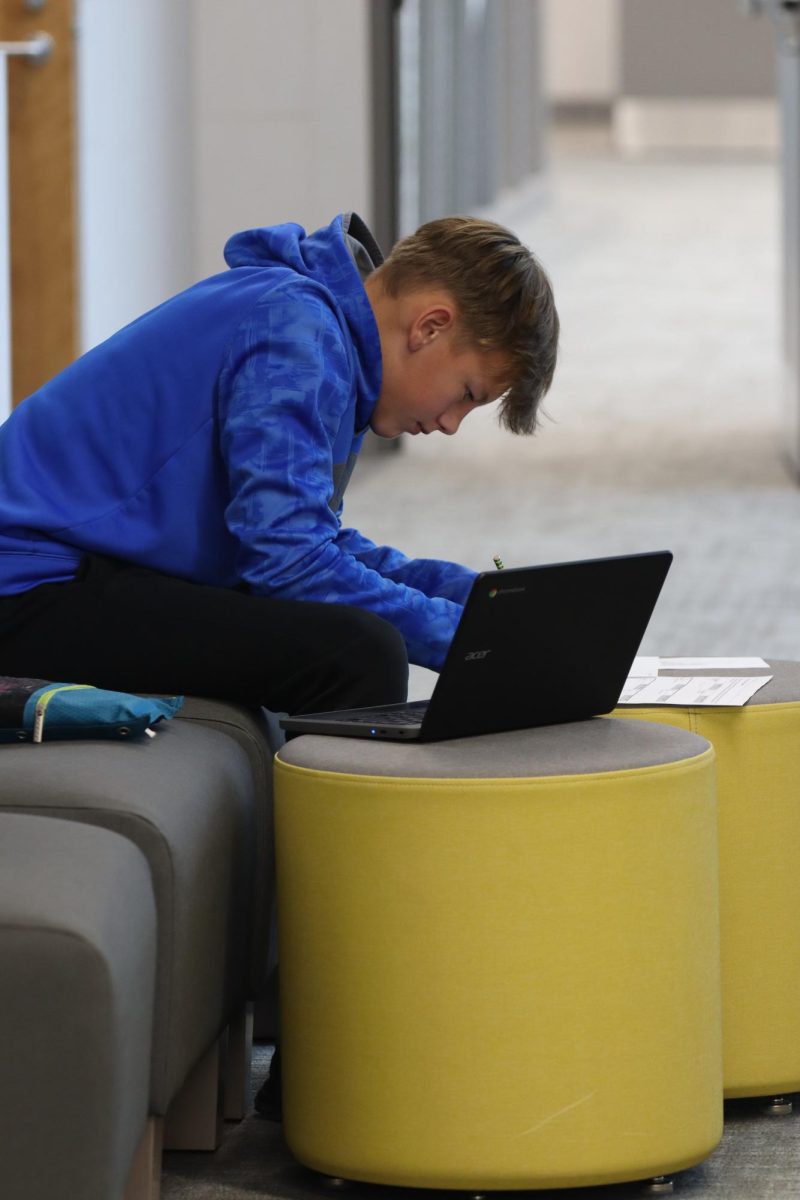 An OHS student is hard at work in the open hallway.