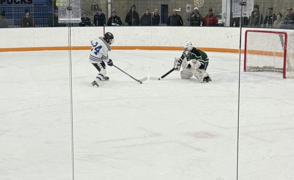 Junior Will Radel takes on the  goalie one on one. 