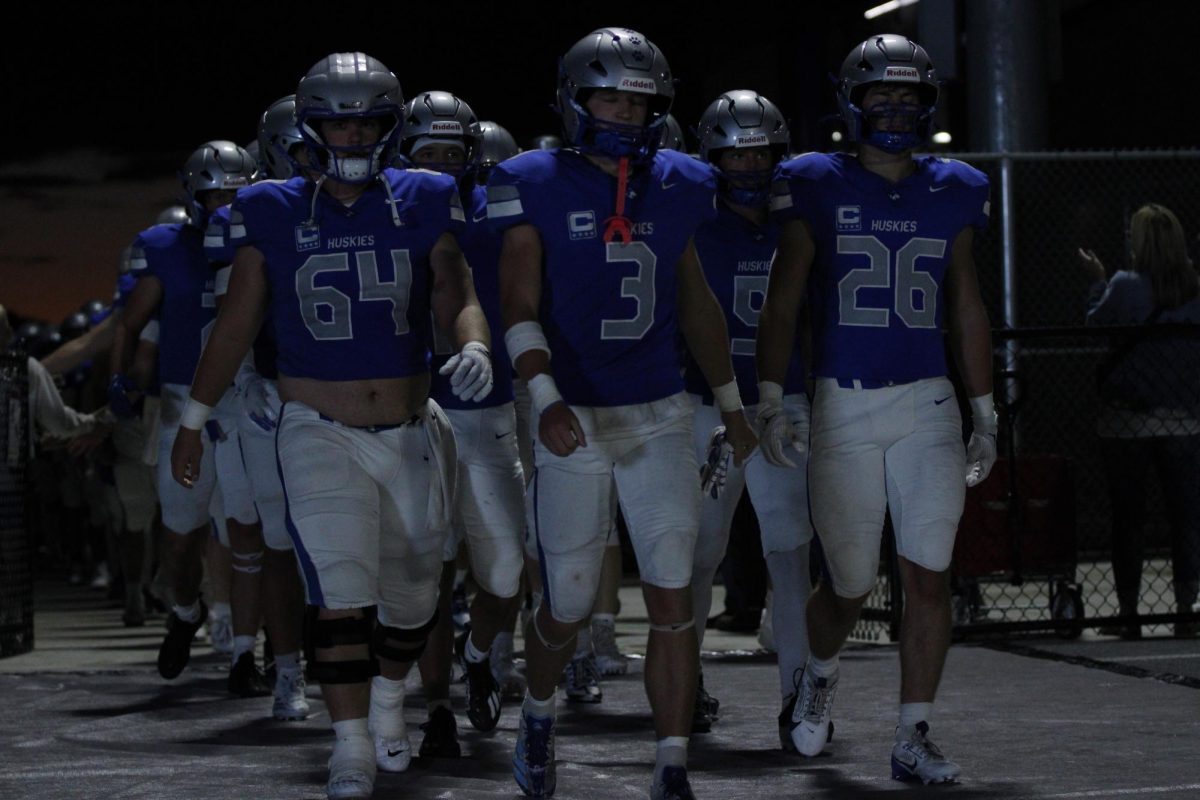 Owatonna football captains leading the Huskies out against Chanhassen.