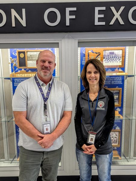 Mr. Achterkirch and Ms. Benson stand with pride of the many athletic awards awarded to students. 