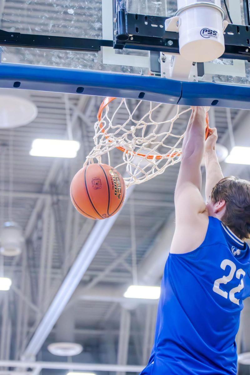 Senior Zach Haarstad confidently dunks the basketball. 