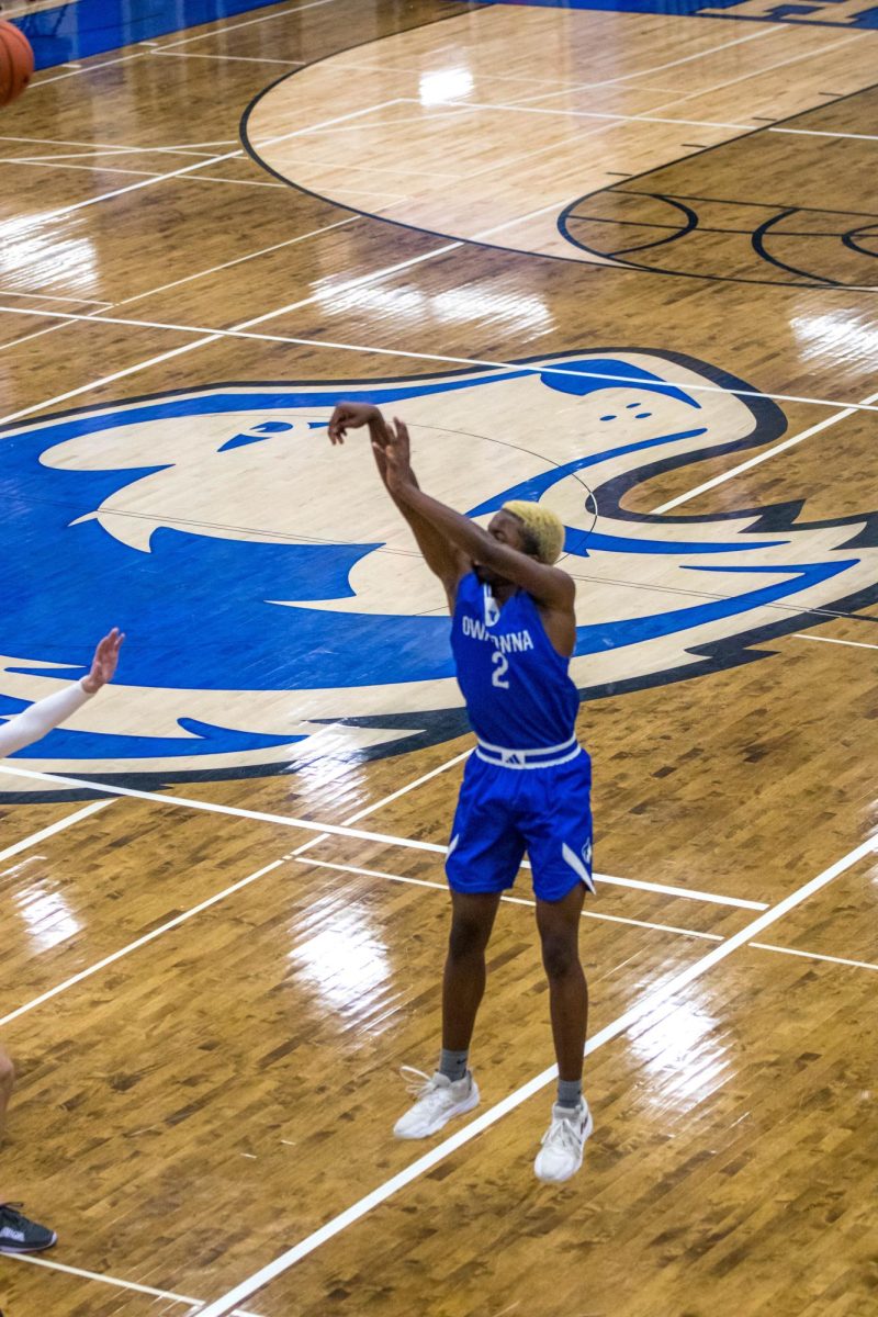 Senior Terrell Miller shoots from behind the three point line.