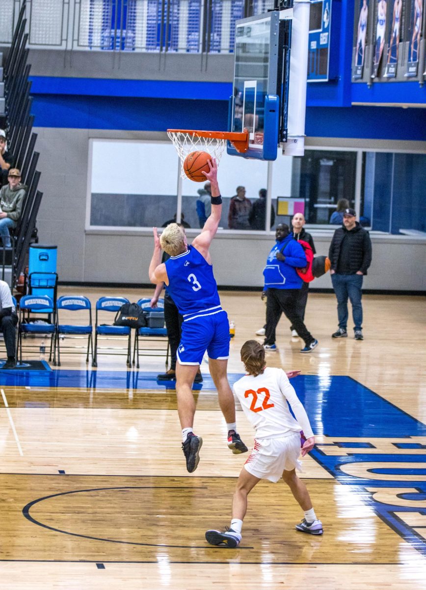 Senior Nolan Ginskey goes up with the ball to make a layup.