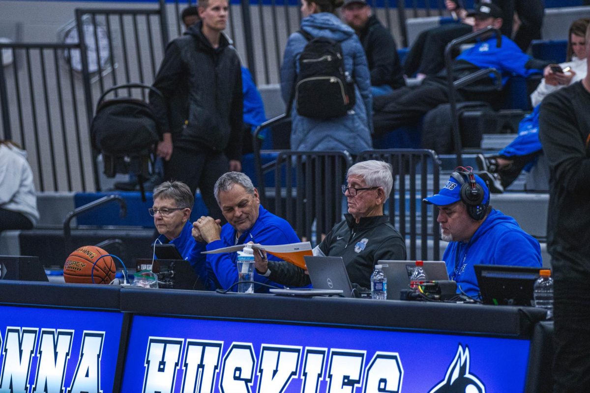 Ms. Sandra Boss, Mr. Kevin Stelter, Mr. Jeff Boss and Mr. Eric Handcock (left to right) work the score tables at basketball games. Their efforts make sporting events possible.