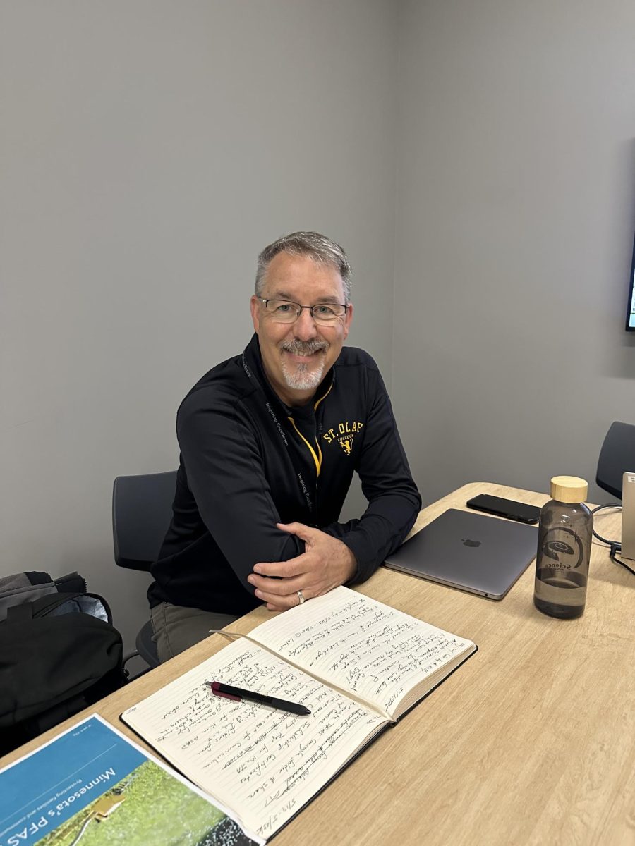 Dr. Meagher in his office is working on his computer. 