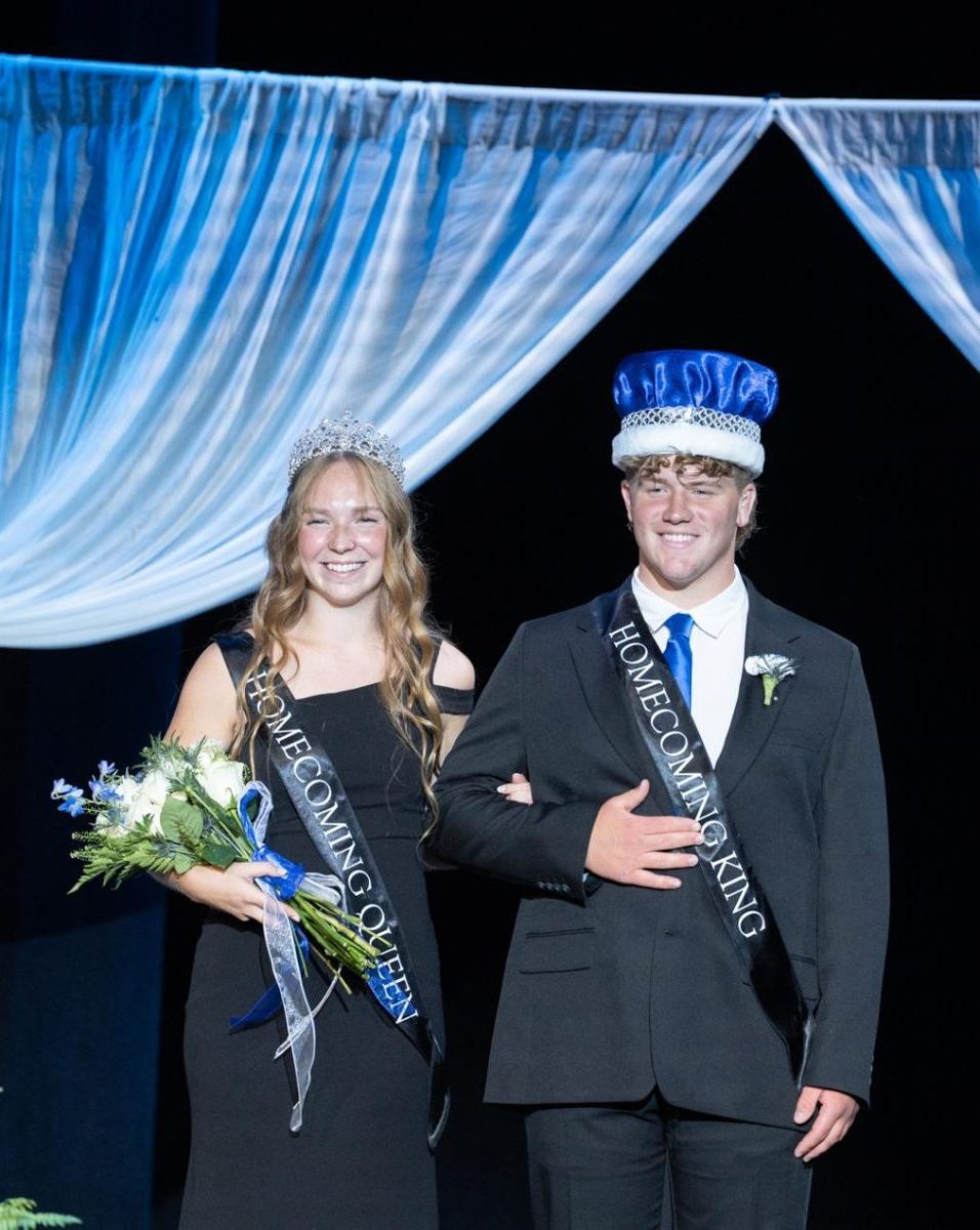 Max Flemke and Mia Armstrong smile to the crowd after being crowned Homecoming King and Queen.