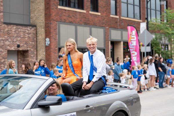 Senior Kendra Bogen (left) and Senior Ethan Borchert (right) ride through the Homecoming parade as a part of Top 12 royalty. 