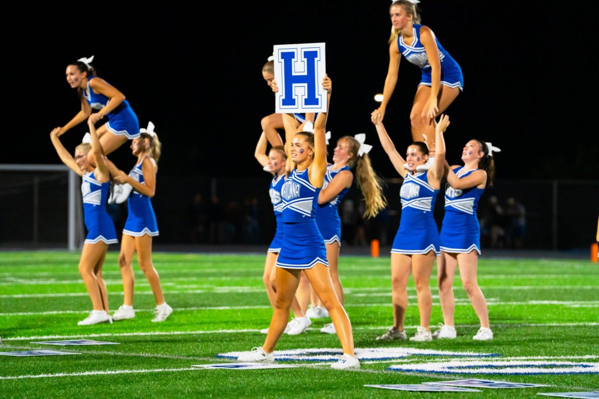 Senior Captian Mia Armstrong and Senior Ellie Vortherms cheer loud at halftime.