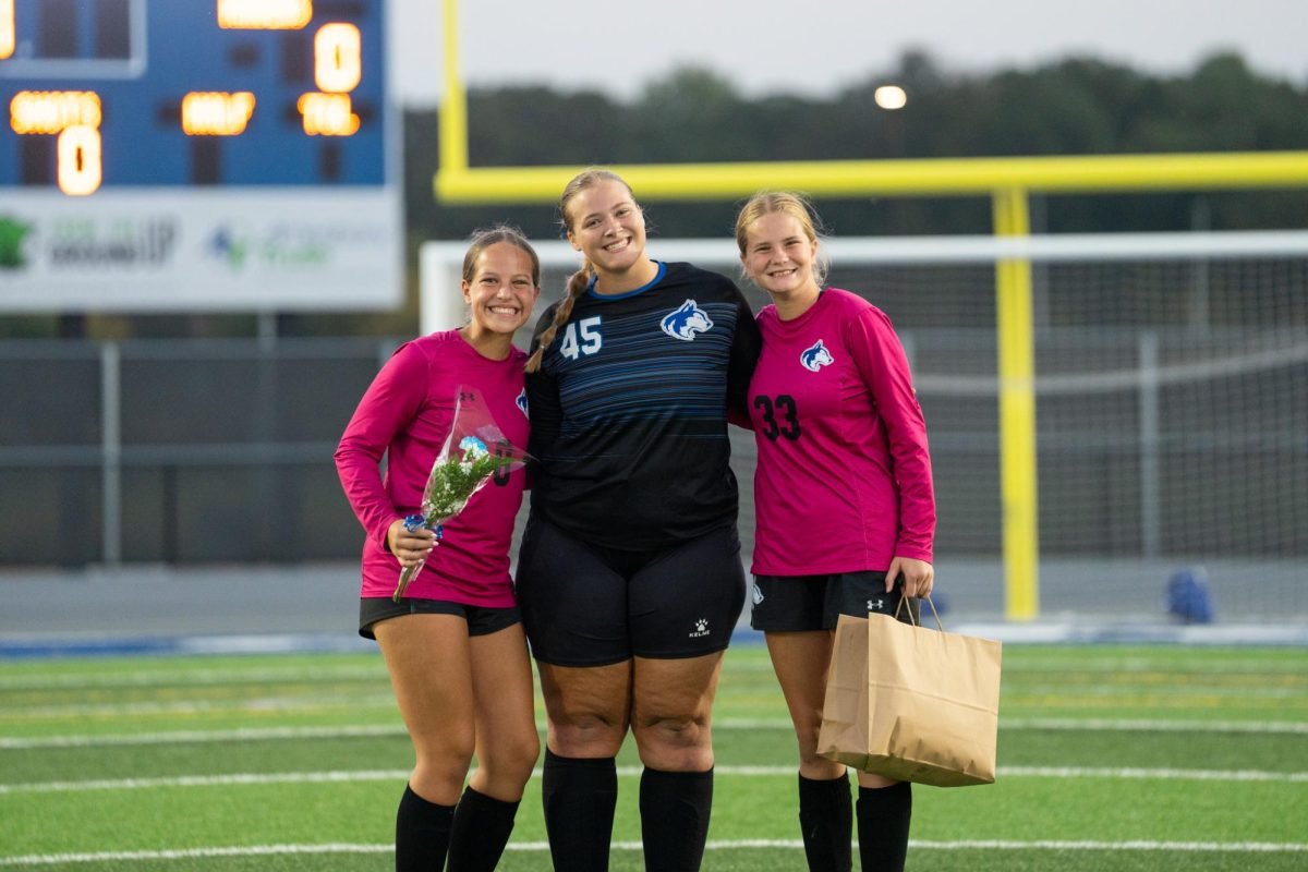 Scarlet takes a photo with the up and coming goalies on senior night.