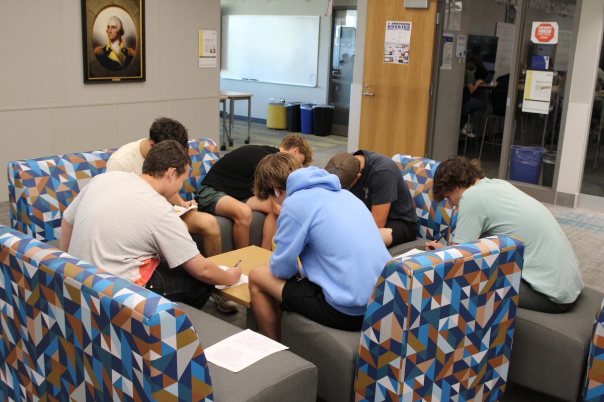 A group of boys working on school work together.