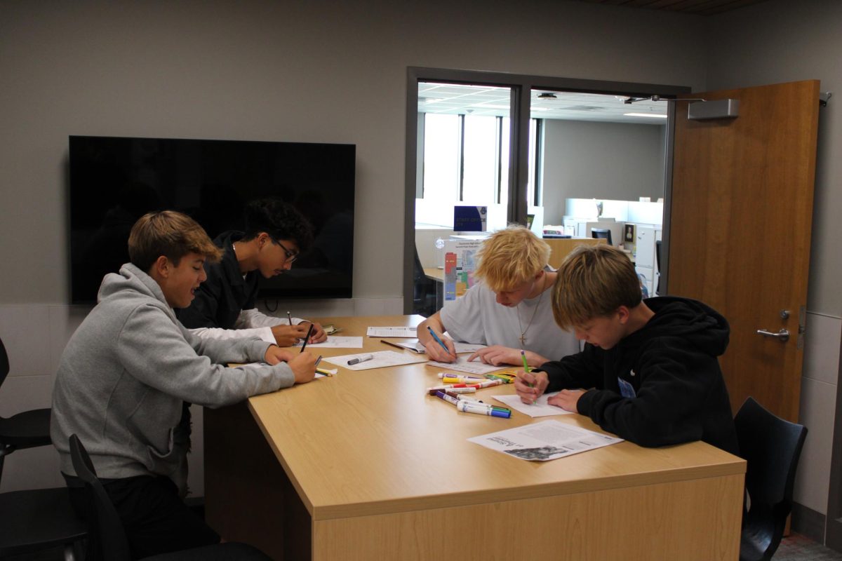 Freshmen Jack Mitchell working on English with his friends.