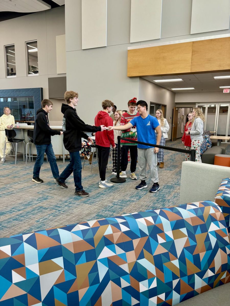 Winners of HO-HO-HO bingo getting there cards checked by student council members. 
