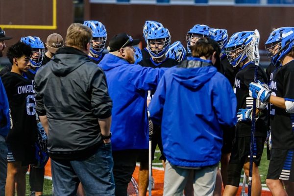 Coach Scott Seykora coaching up his players in between quarters in an intense game