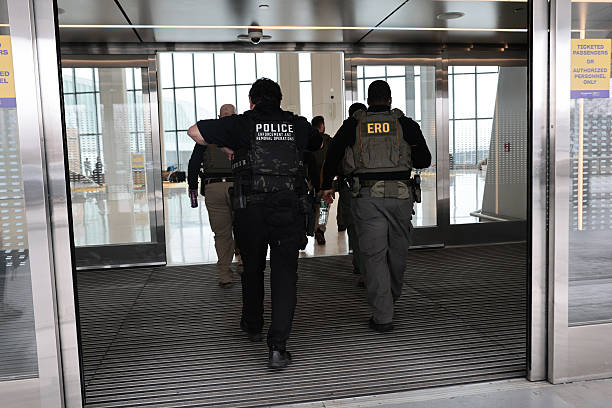 NEW YORK, NEW YORK - MARCH 23:  Immigration and Customs Enforcement (ICE) agents patrol Terminal B at LaGuardia Airport on March 23, 2026 in New York City. The travel disruptions continue as hundreds of TSA agents quit or work without pay during a partial government shutdown. U.S. President Donald Trump said ICE agents will be deployed to U.S. airports on Monday, with border czar Tom Homan in charge of the effort. (Photo by Michael M. Santiago/Getty Images)