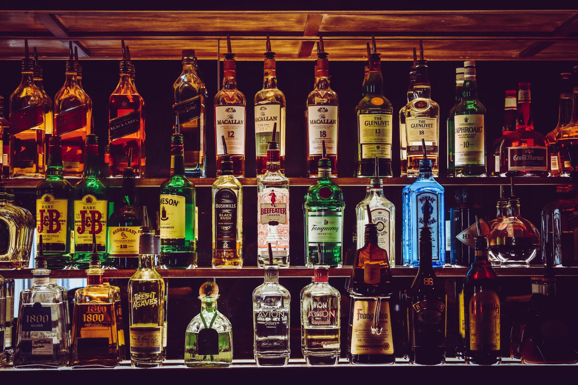 Alcohol lined up showcasing different kinds of booze. (Source: https://www.pexels.com/photo/assorted-wine-bottles-1283219/)