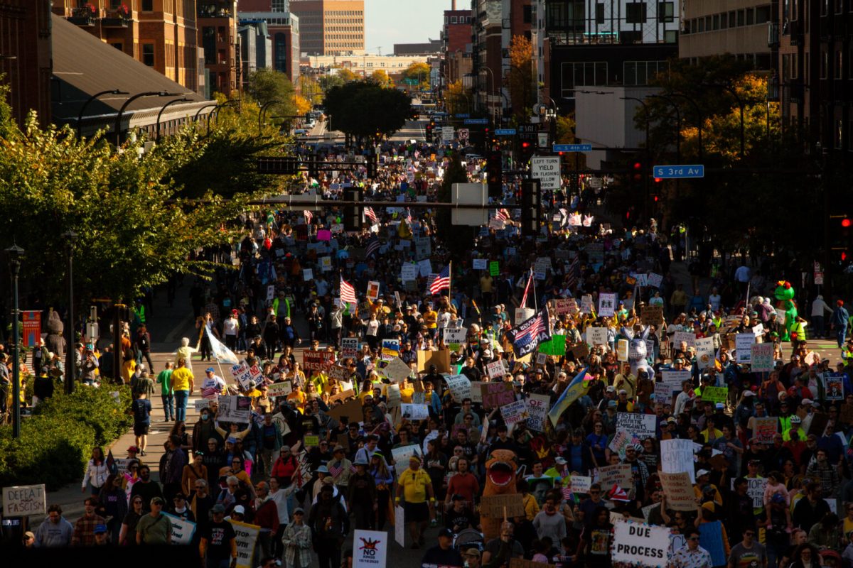 Thousands march through downtown Minneapolis for the No Kings day rally Saturday, Oct. 18, 2025, protesting what many see as overreaches of power by the Trump administration. 