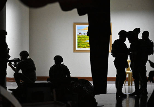 Philippine troops exchange gunshots inside the Senate of the Philippines in Pasay, Metro Manila on May 13, 2026. 
