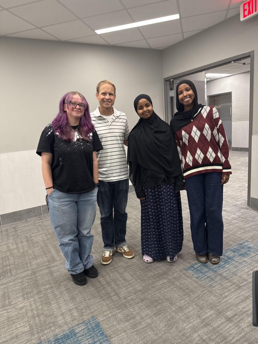 A photo of Morgan Hougas, Ramala Dahir, and Amal Mohamed standing side by side with Daniel Leer, Yearbook advisor as they say goodbye to Yearbook for the summer.